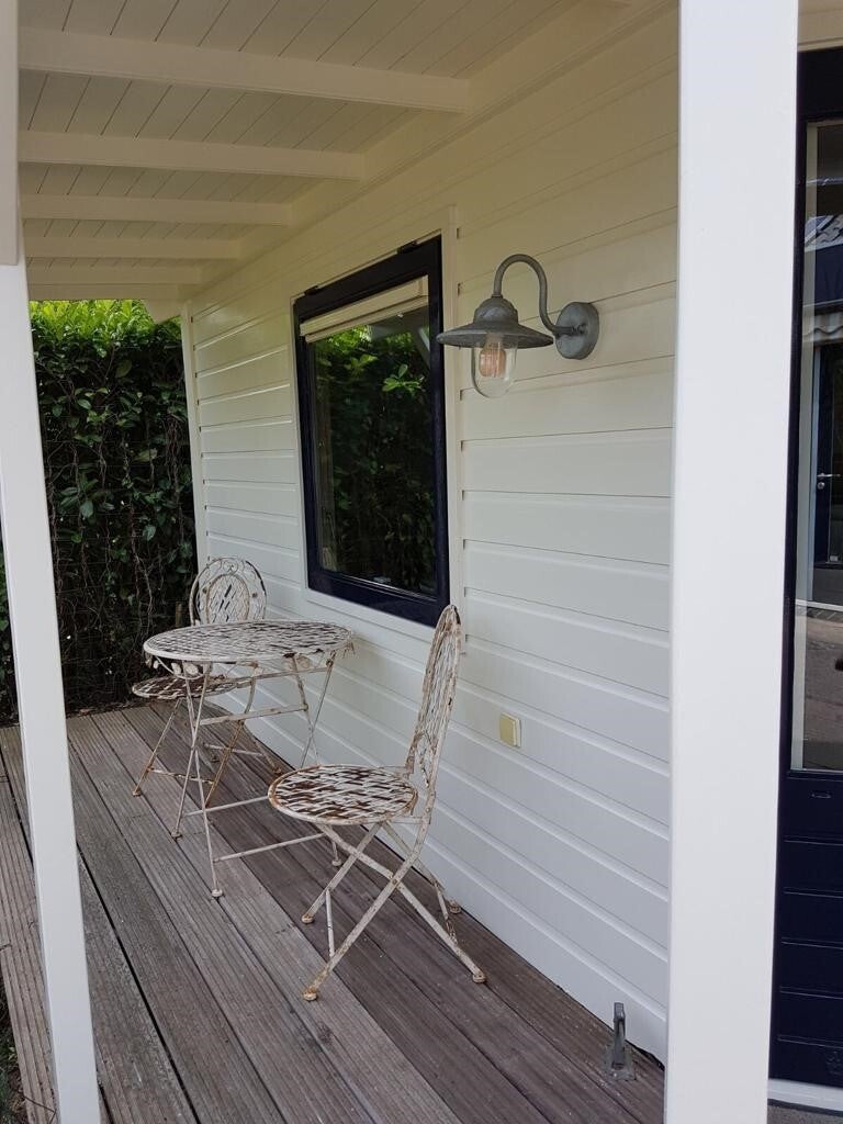 Afgewerkte veranda met strak gelakt houtwerk